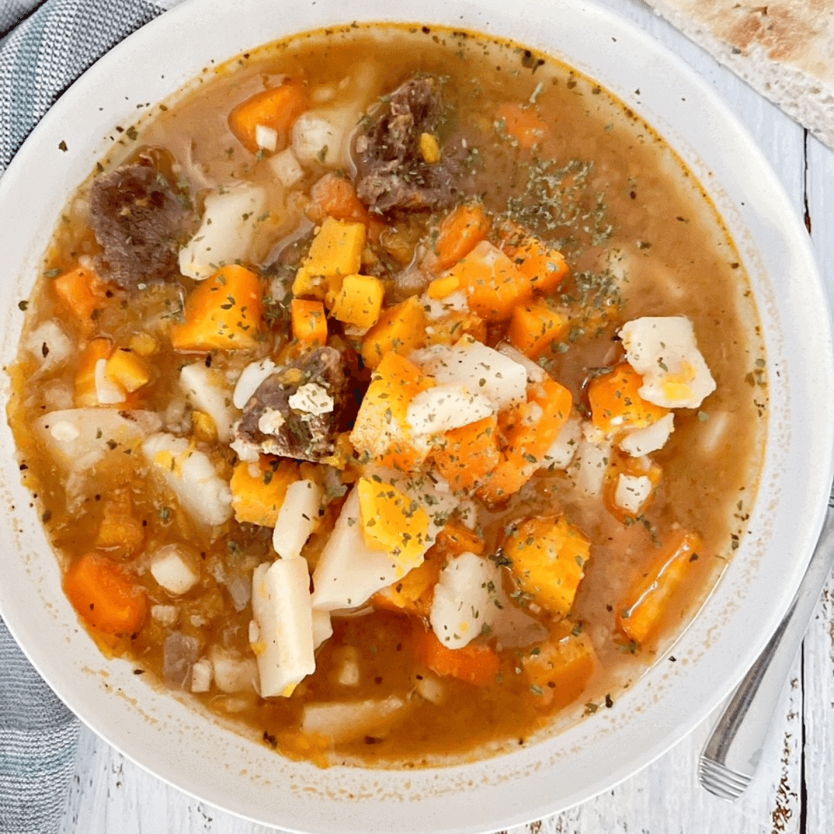 Closeup of venison stew in white bowl