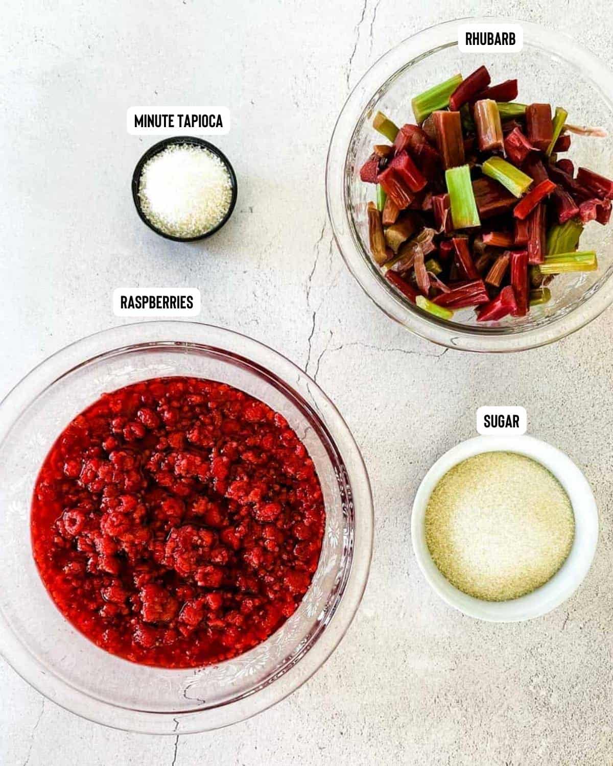 Ingredients for raspberry rhubarb jam placed on table.