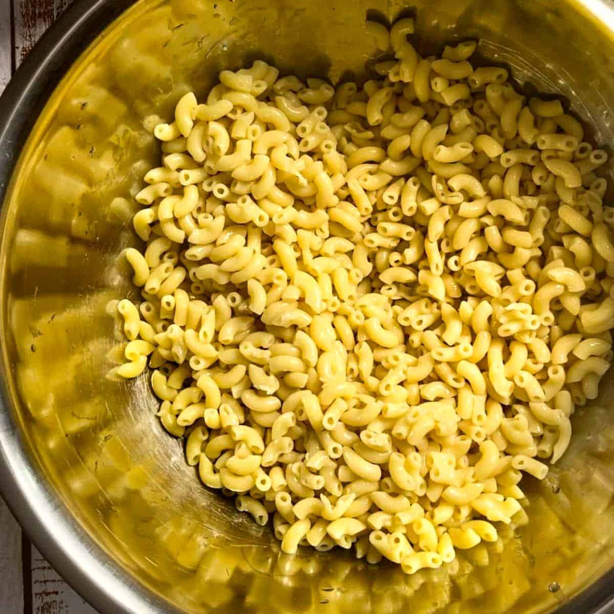 Cooked macaroni noodles drained and placed in large mixing bowl.