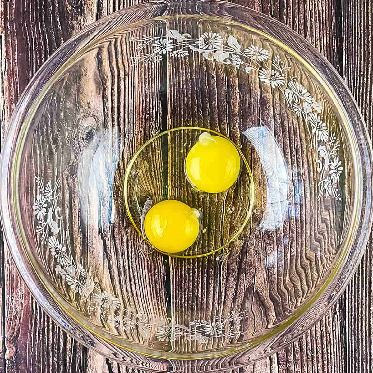 The eggs in a large mixing bowl.