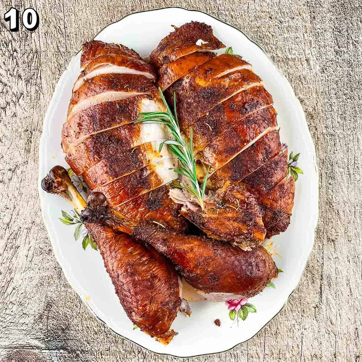 The smoked turkey carved and sliced and placed on a turkey platter.