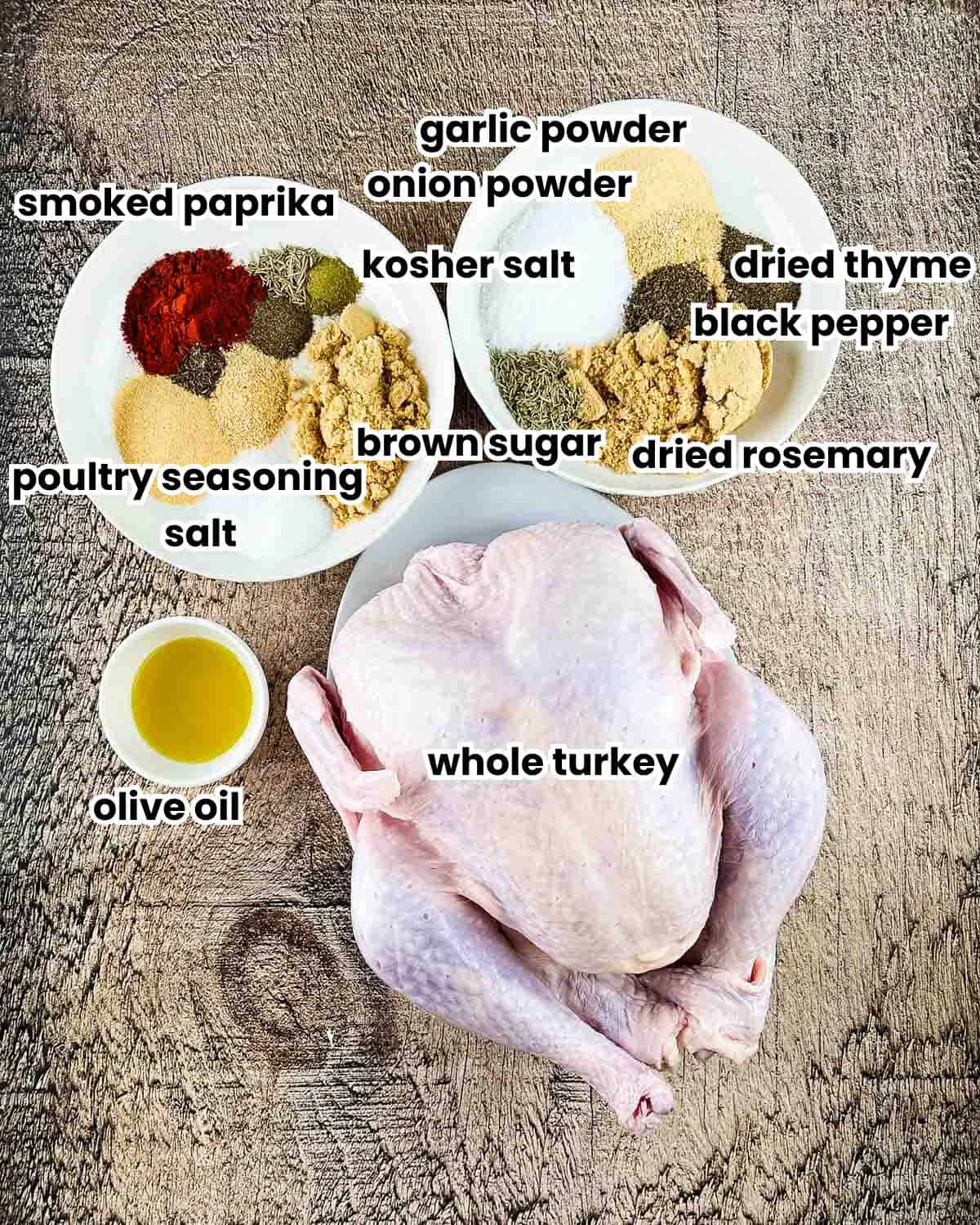 Ingredients for smoked turkey in electric smoker recipe labeled and arranged on a wooden table.