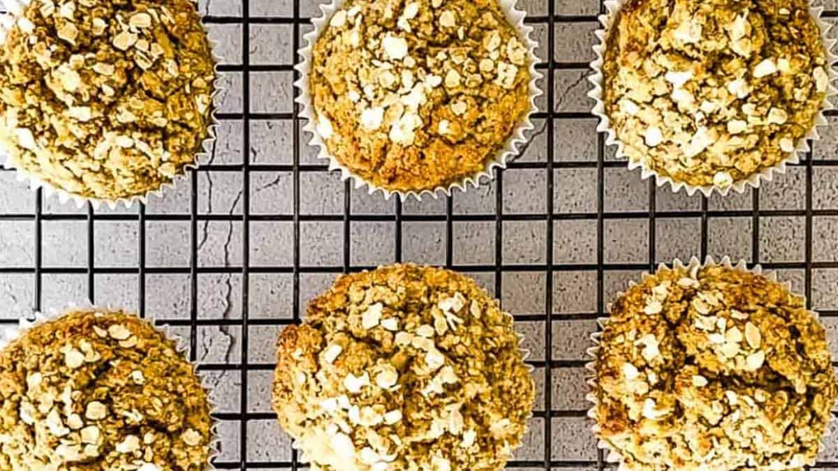 Baked apple cinnamon oatmeal muffins cooling on a cooling rack.