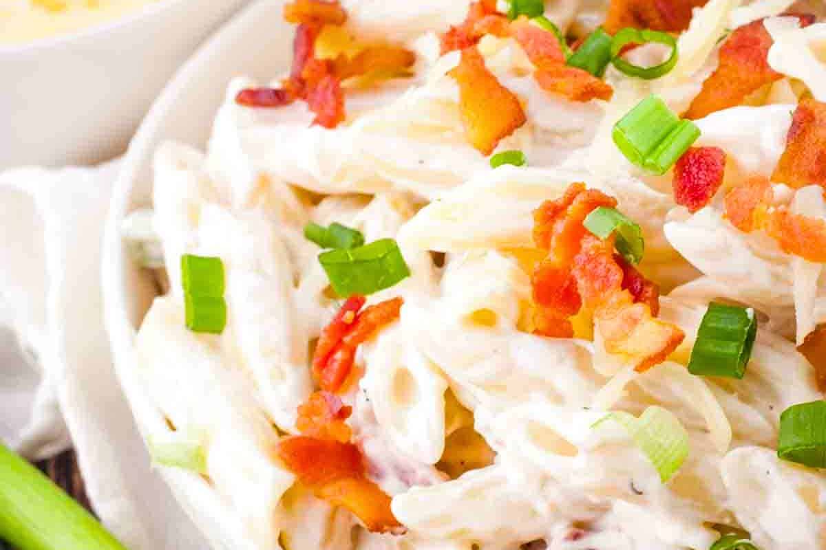 A bowl of Bacon Ranch Pasta Salad featuring creamy ranch dressing, crispy bacon, and tender pasta, perfect for any occasion.