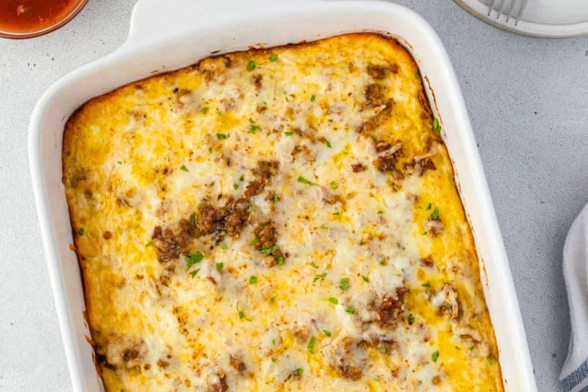 A freshly baked Green Chile Breakfast Casserole in a rectangular dish, showing layers of fluffy eggs, melted cheese, and diced green chiles.