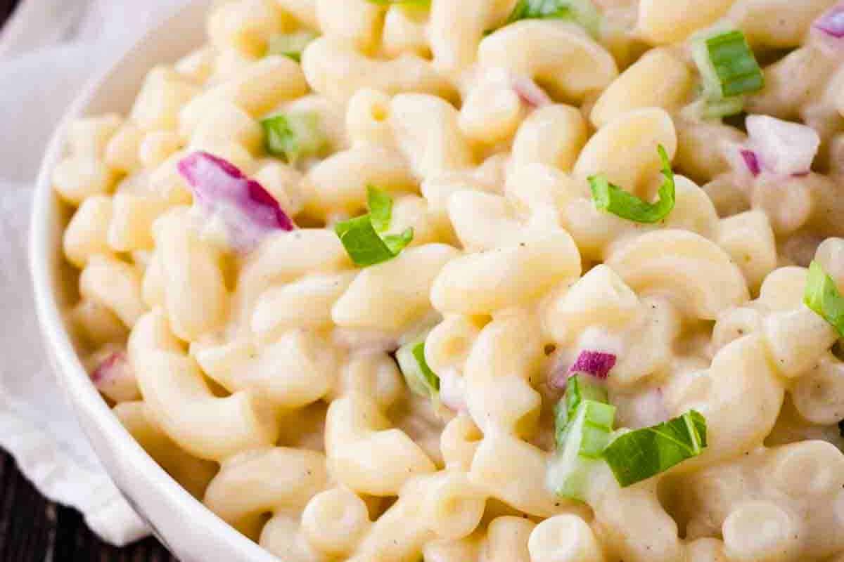 A bowl of classic Hawaiian Macaroni Salad featuring tender macaroni in a sweet and creamy homemade dressing.