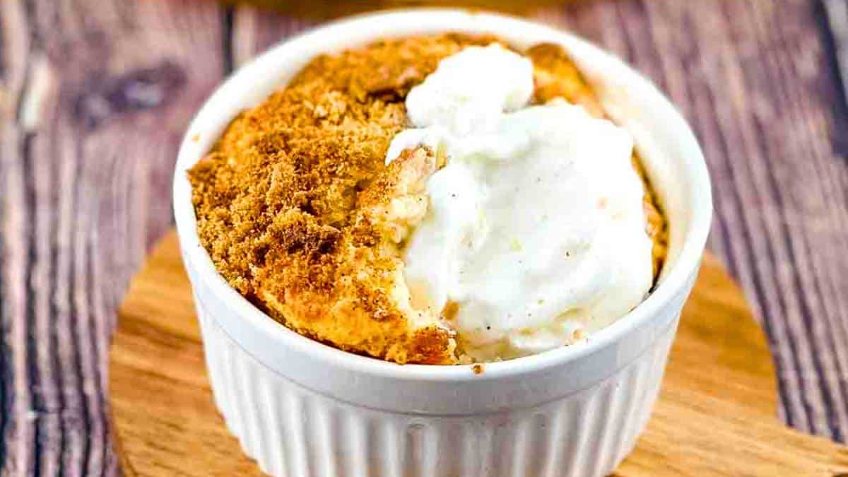 Peach Cobbler with a golden crust and juicy peach filling, served in a baking dish.