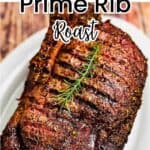 A reverse seared smoked prime rib roast on a serving platter, garnished with fresh rosemary.