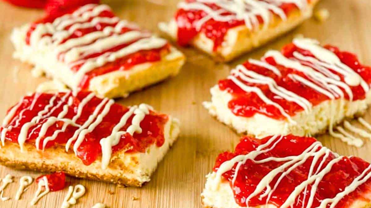 Strawberry Cheesecake Snack Bars with a graham cracker crust, creamy cheesecake layer, and strawberry topping.