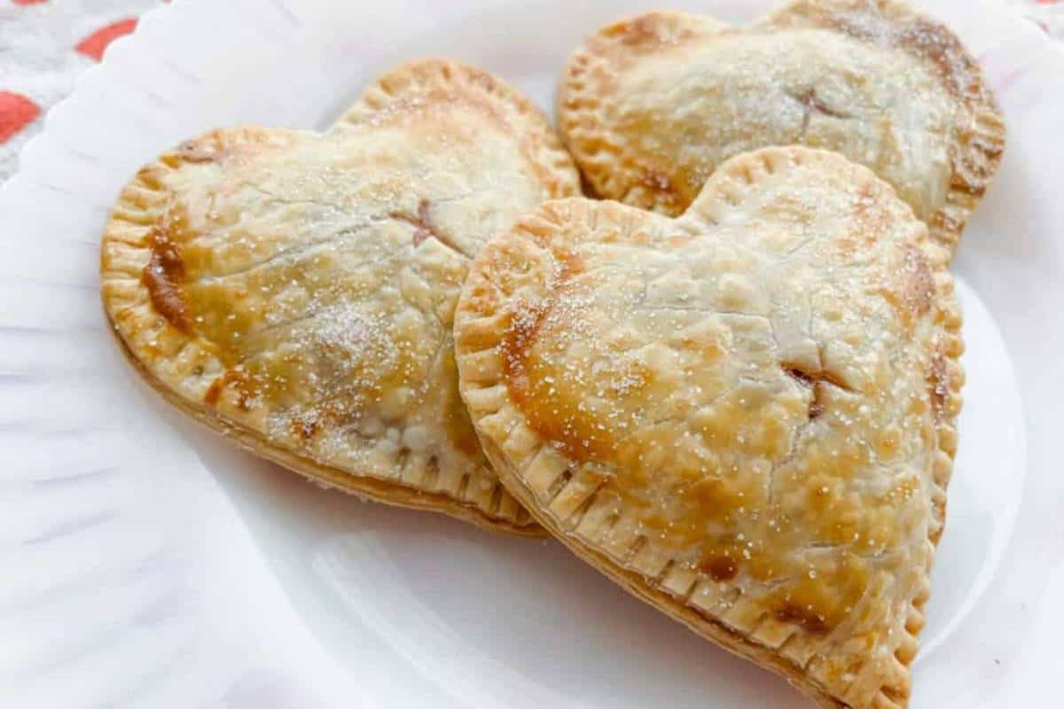 Strawberry hand pies on a white dinner plate, ready to be served.