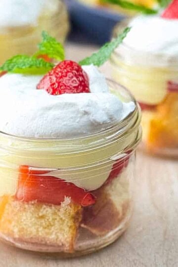 Strawberry Shortcake Parfait in a Jar with layers of cake, fresh strawberries, and whipped topping in a mason jar.
