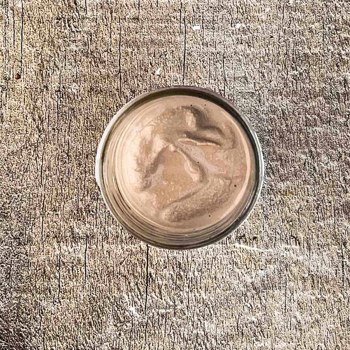 Freshly made chocolate milkshake in the pint jar, ready to be poured into a glass.