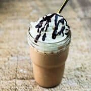 Delicious Ninja Creami chocolate milkshake in a tall glass, garnished with whipped cream and chocolate syrup.
