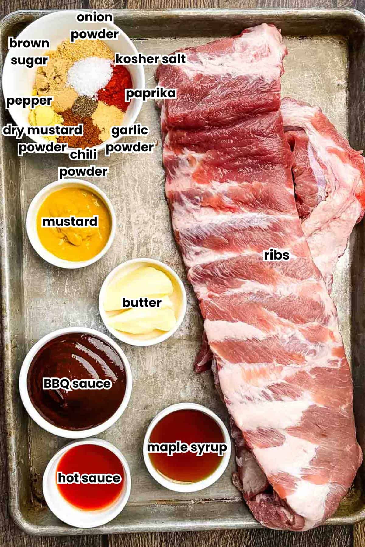 The ingredients needed for smoked party ribs, including pork ribs, mustard, BBQ sauce, maple syrup, hot sauce, and various spices.