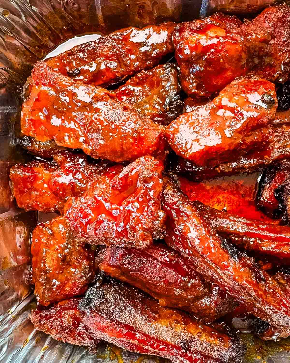 Platter of smoked party ribs, beautifully glazed, ready to serve.