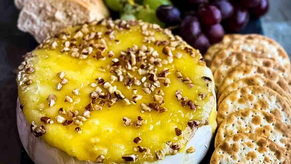 A gorgeous wheel of melted brie drizzled with golden honey and topped with nuts.