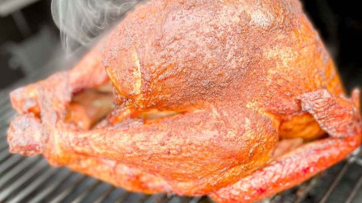 A juicy smoked turkey on a pellet grill, ready to be served.