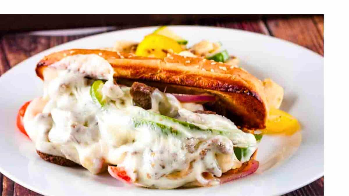 A loaded Philly cheesesteak sandwich with tender sliced venison, melted cheese, and caramelized onions.