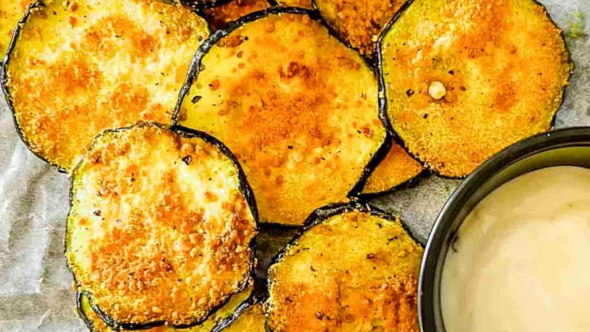 Golden rounds of zucchini topped with crispy parmesan and herbs.