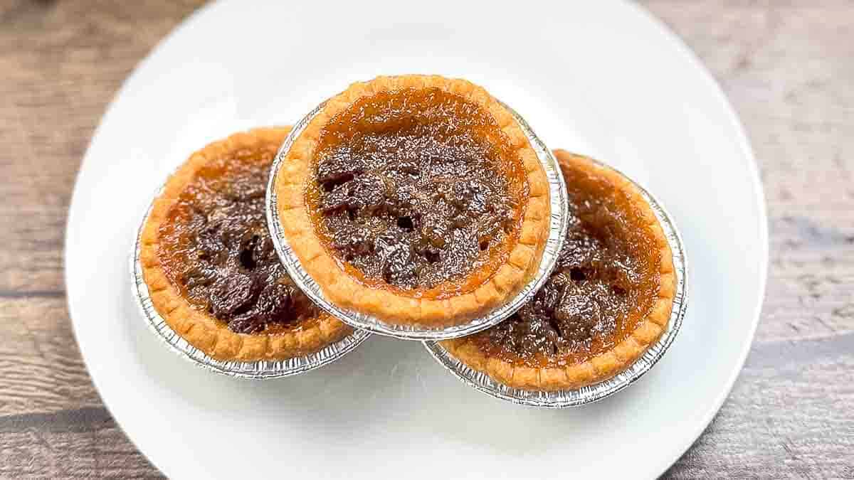 Classic butter tarts arranged on a plate, ready to serve.