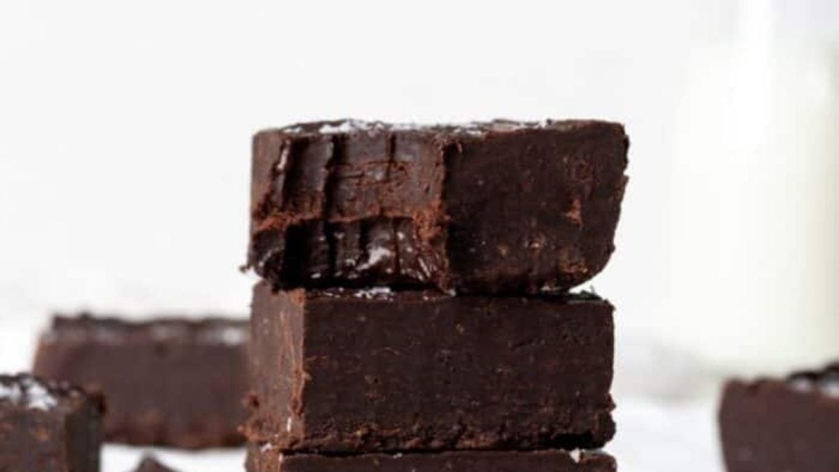 Rich, dark chocolate fudge squares arranged to show their perfectly smooth, glossy surface.