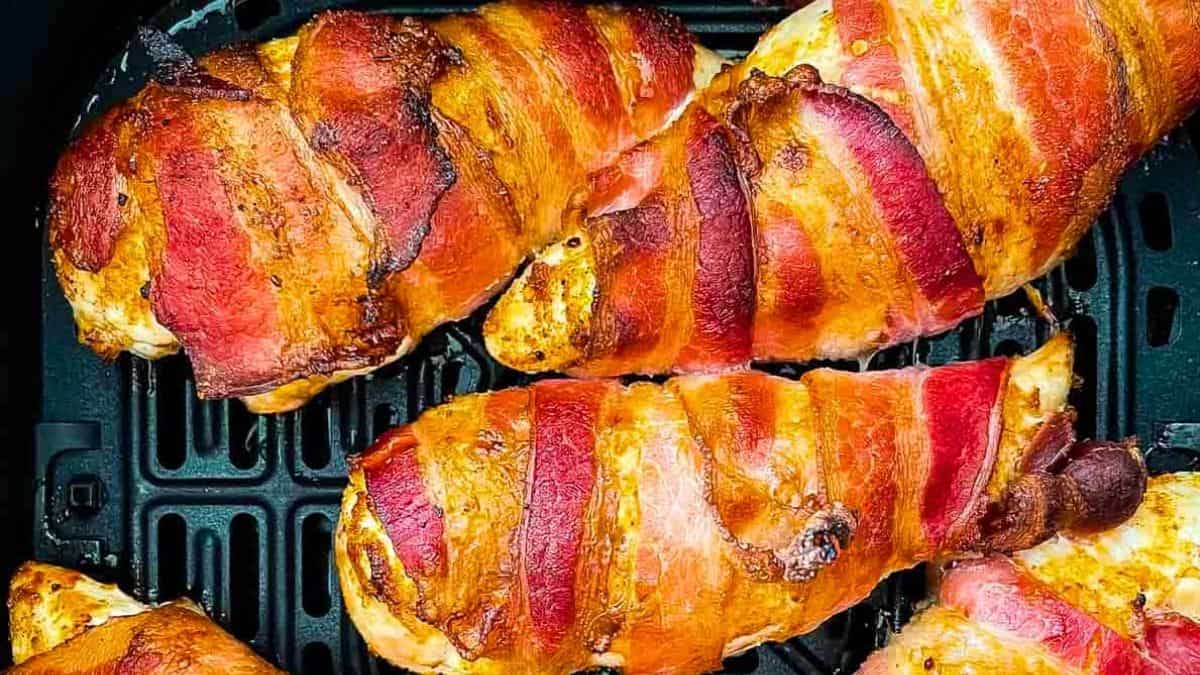 Juicy chicken breasts wrapped in crispy bacon, perfectly cooked in the air fryer.
