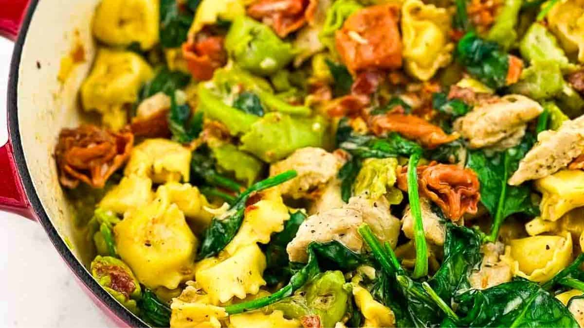 Creamy marry me tortellini chicken ready to serve in a large cast iron skillet.