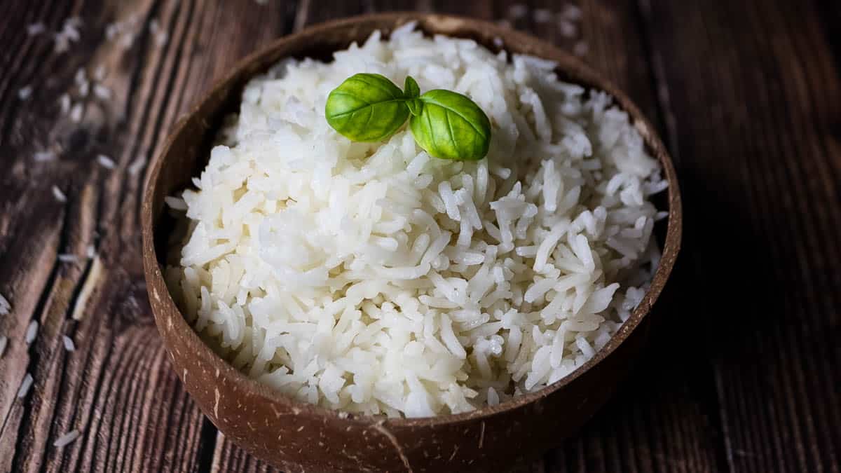 Perfectly cooked fluffy white rice in serving bowl, showing individual grains.