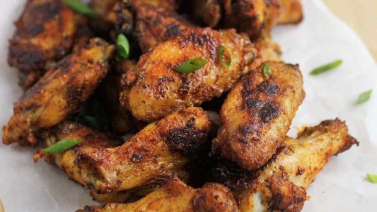 Crispy Cajun wings on a serving platter, garnished with parsley.