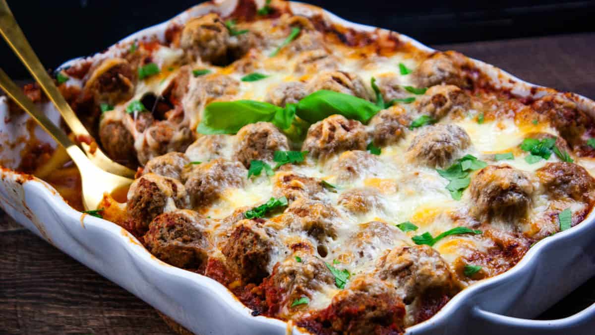 Baked meatball casserole with melted cheese and marinara sauce bubbling around the edges