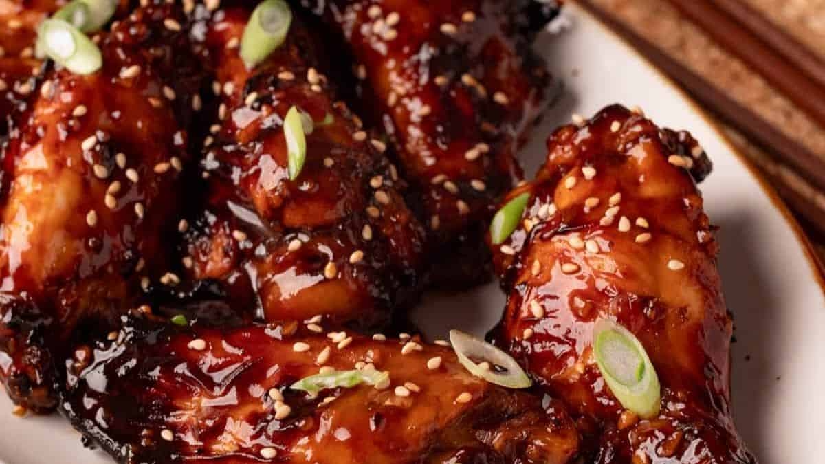 Dark brown wings glazed with honey soy sauce and sesame seeds.