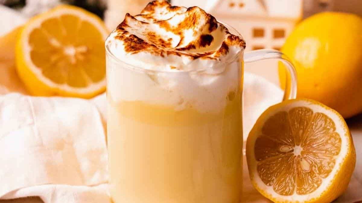 Pale yellow hot chocolate with a toasted meringue topping that looks like a mini pie.