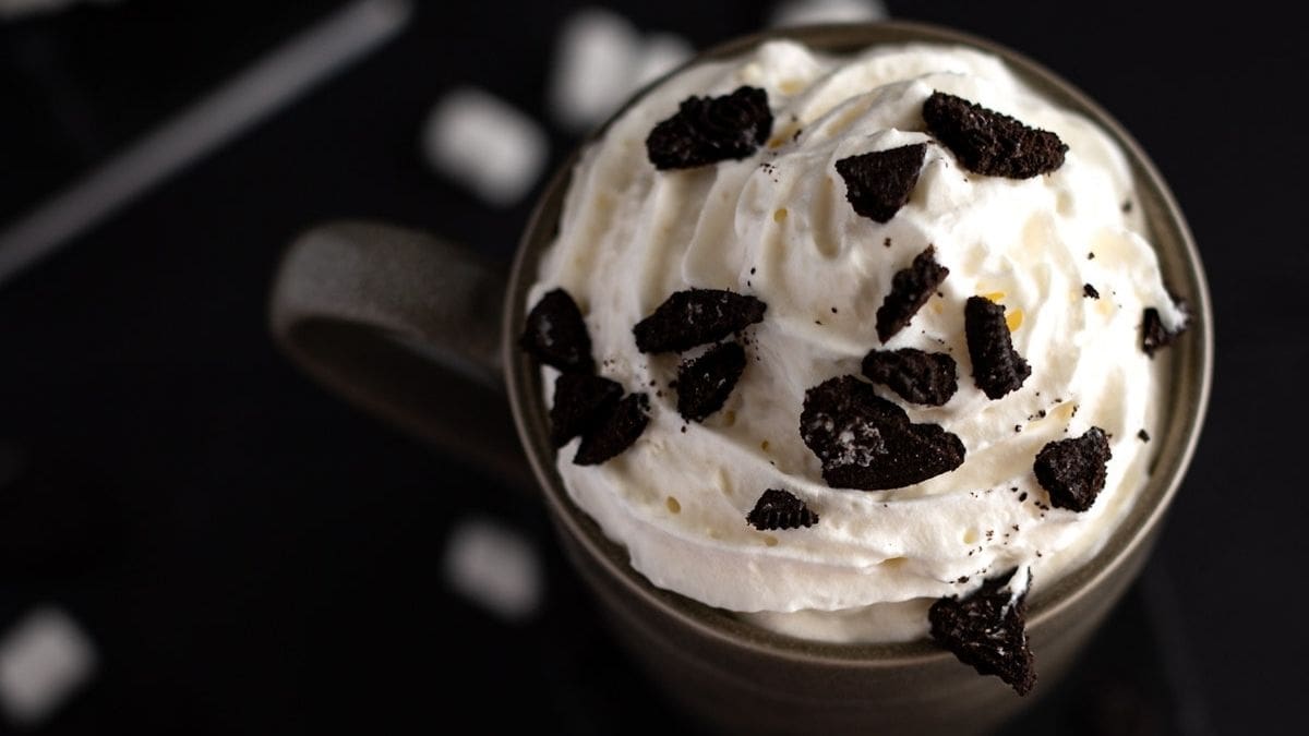Hot chocolate with crushed Oreos on top of whipped cream.
