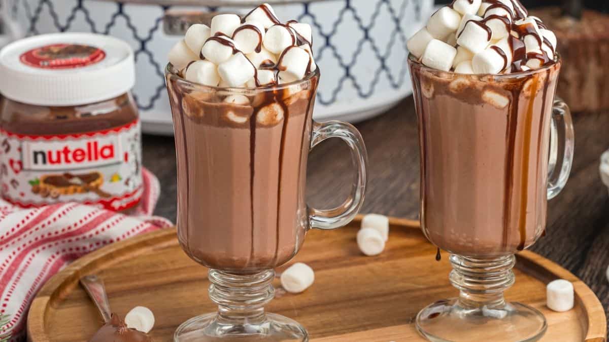 Nutella hot chocolate topped with whipped cream, mini marshmallows, and drizzled Nutella.