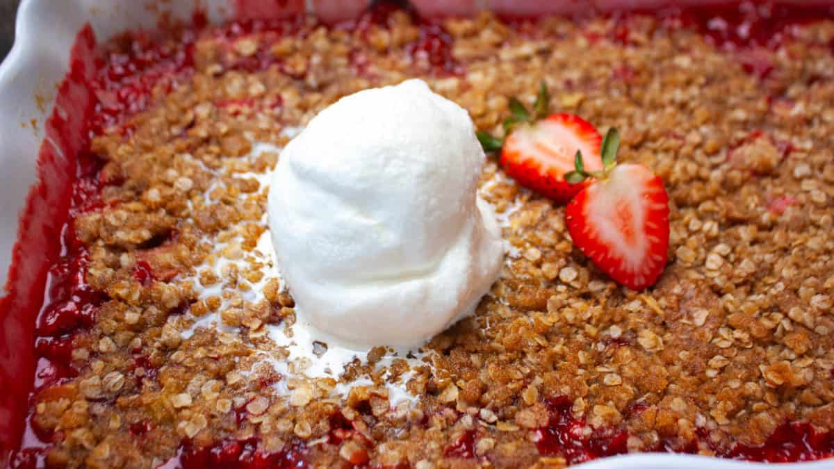 Warm strawberry rhubarb dessert showing sweet-tart filling and crispy oat crumble topping.