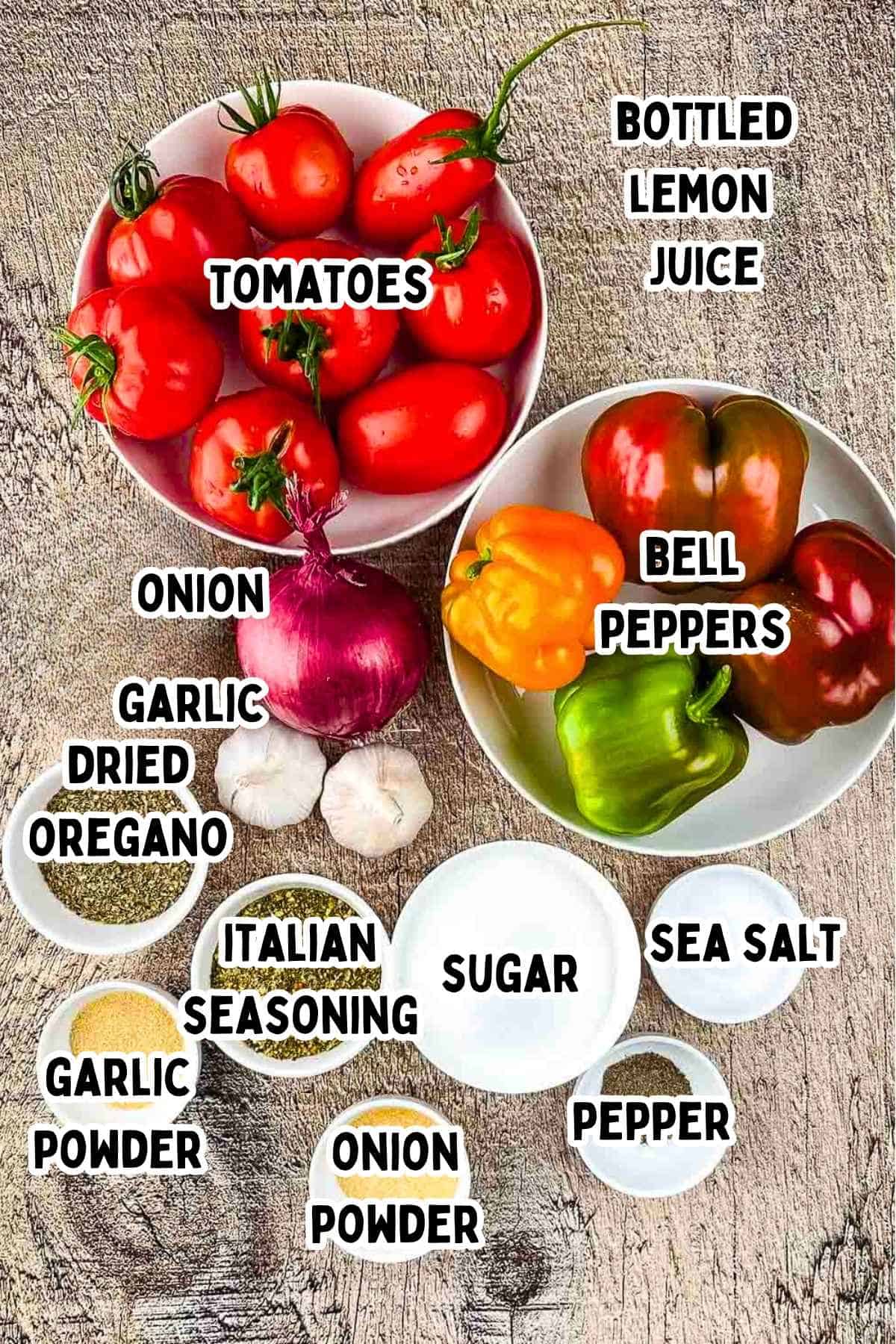 Labeled ingredients for homemade canned spaghetti sauce on a wooden table.