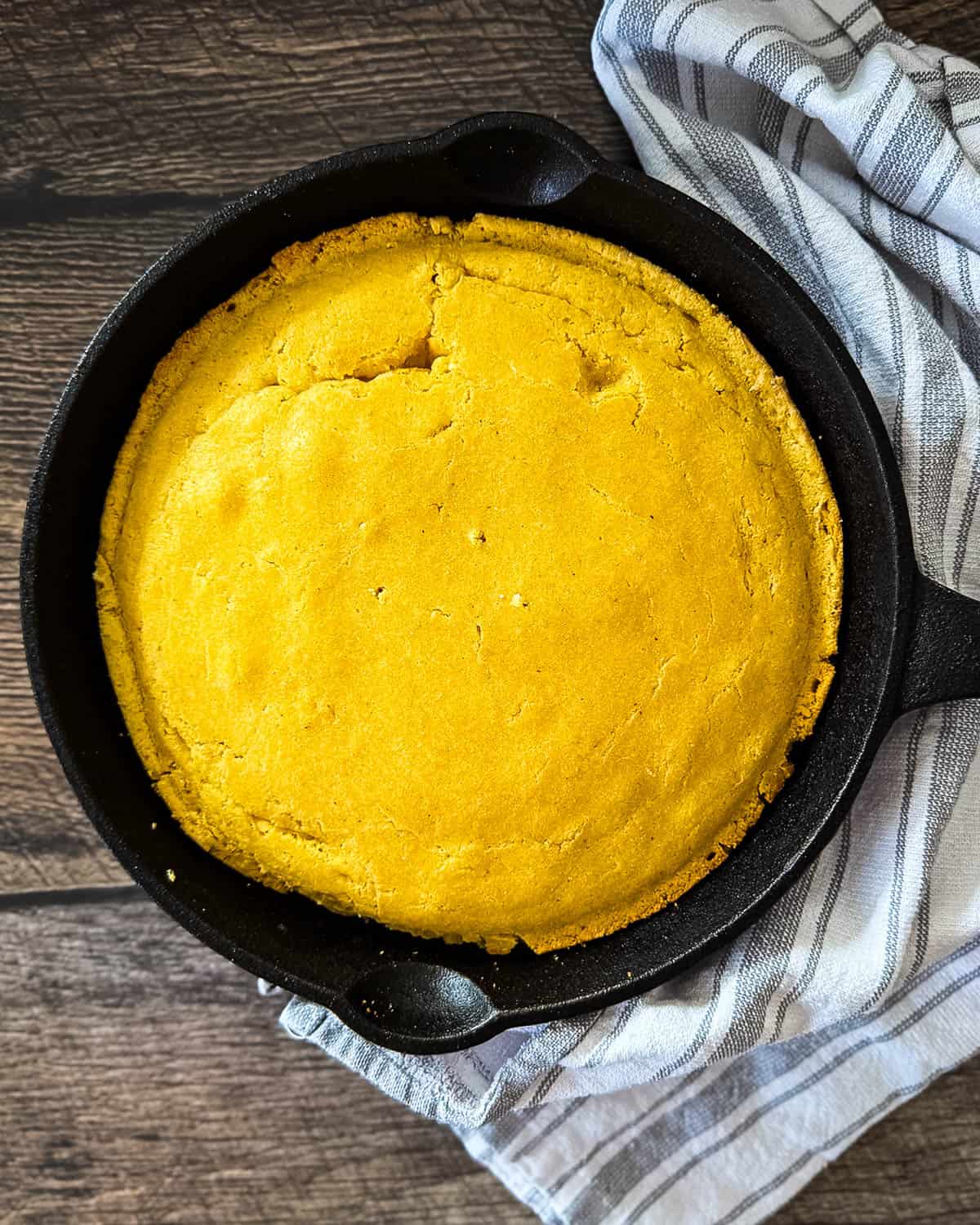 Cooling smoked cornbread in skillet before slicing.