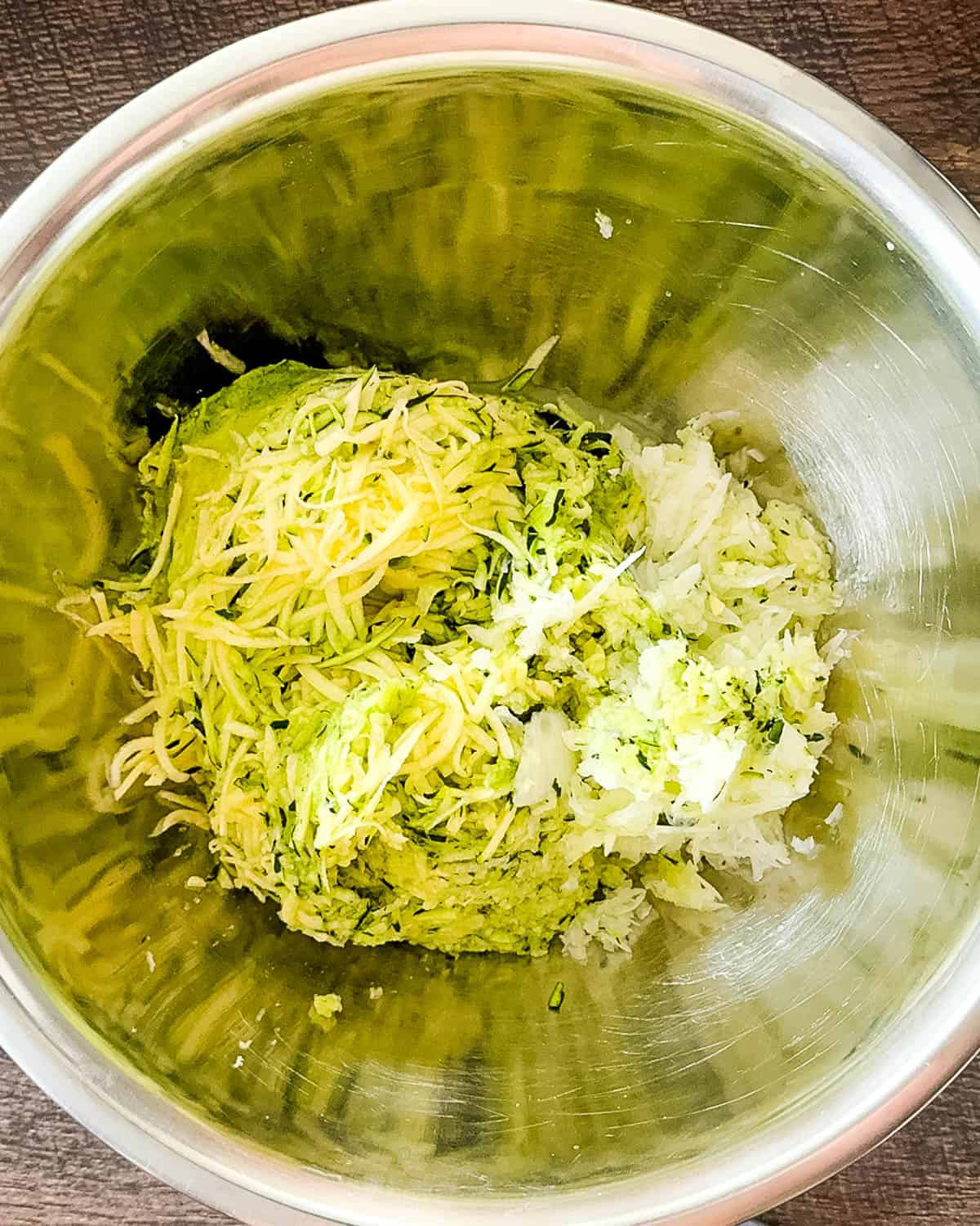Salted zucchini and onion mixture rinsed with water to remove excess salt and pressed dry with a clean towel.