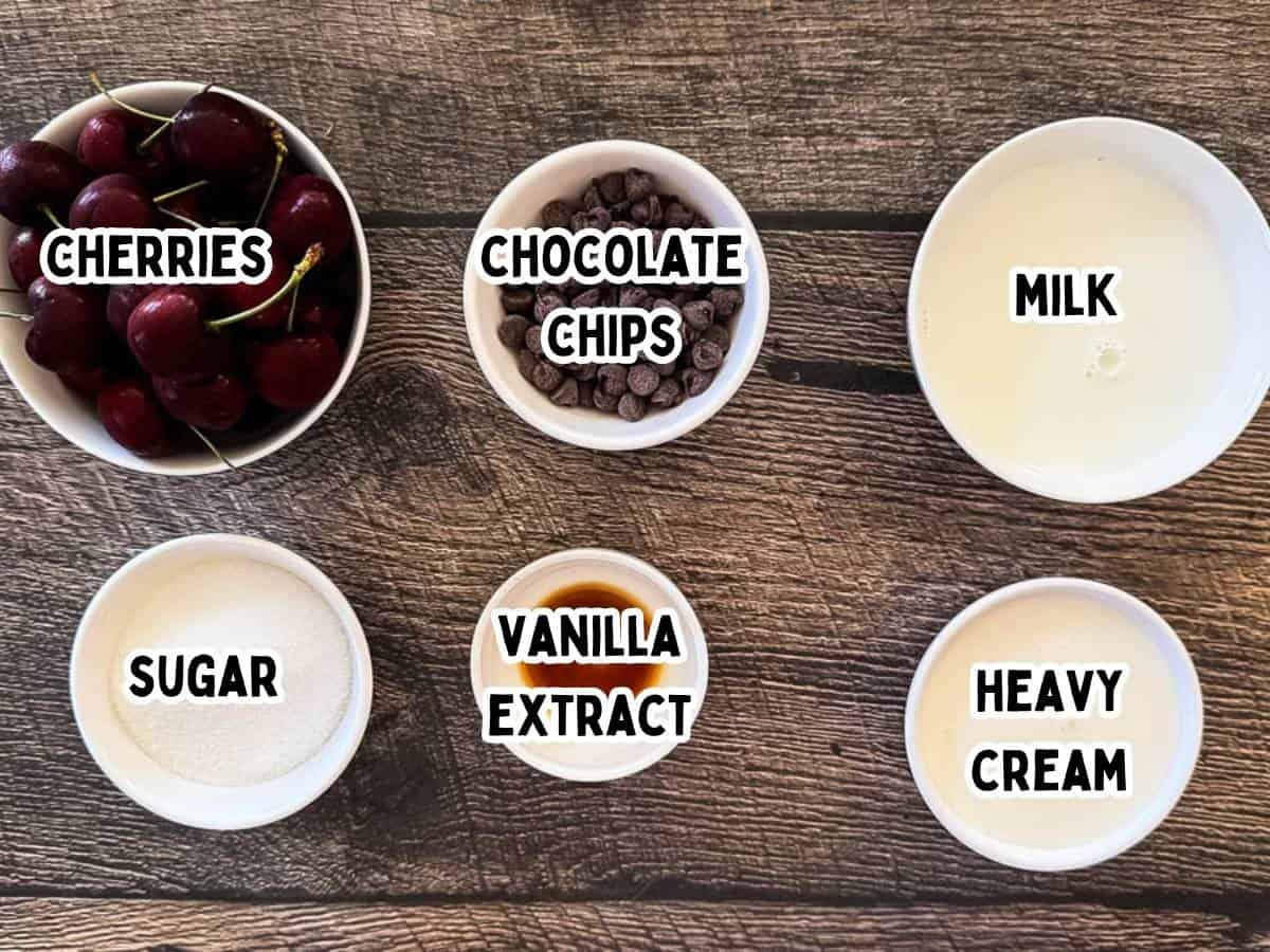 Labeled ingredients for Ninja Creami Cherry Chocolate Chip Ice Cream on a wooden board.