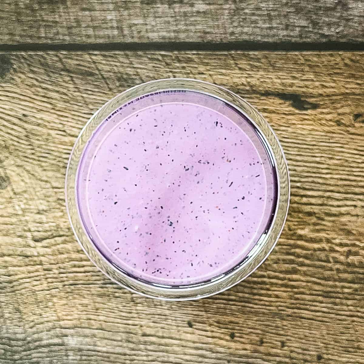 The ice cream mixture in a Ninja Creami pint jar before the lid is secured.