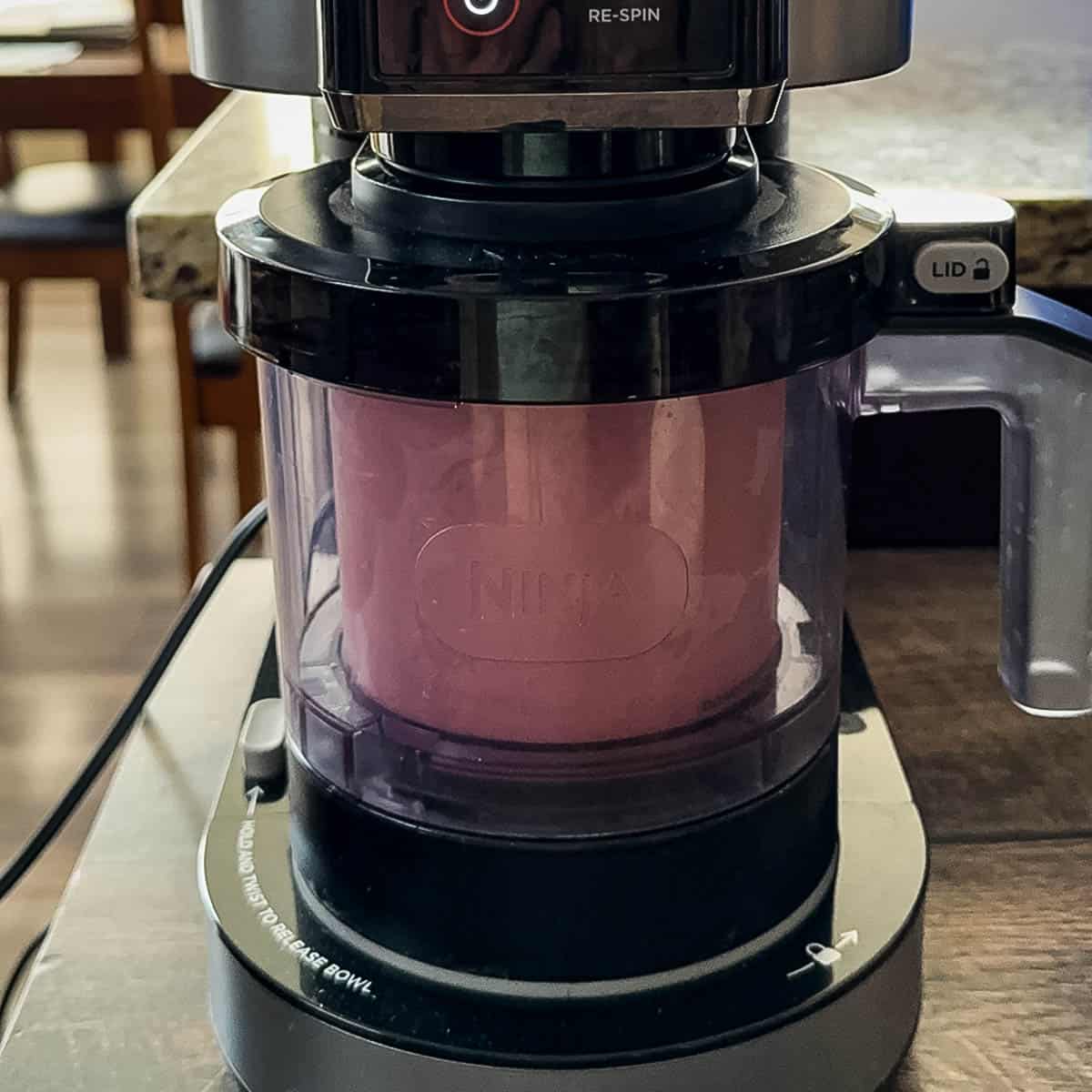 The pint jar being processed in the Ninja Creami machine.