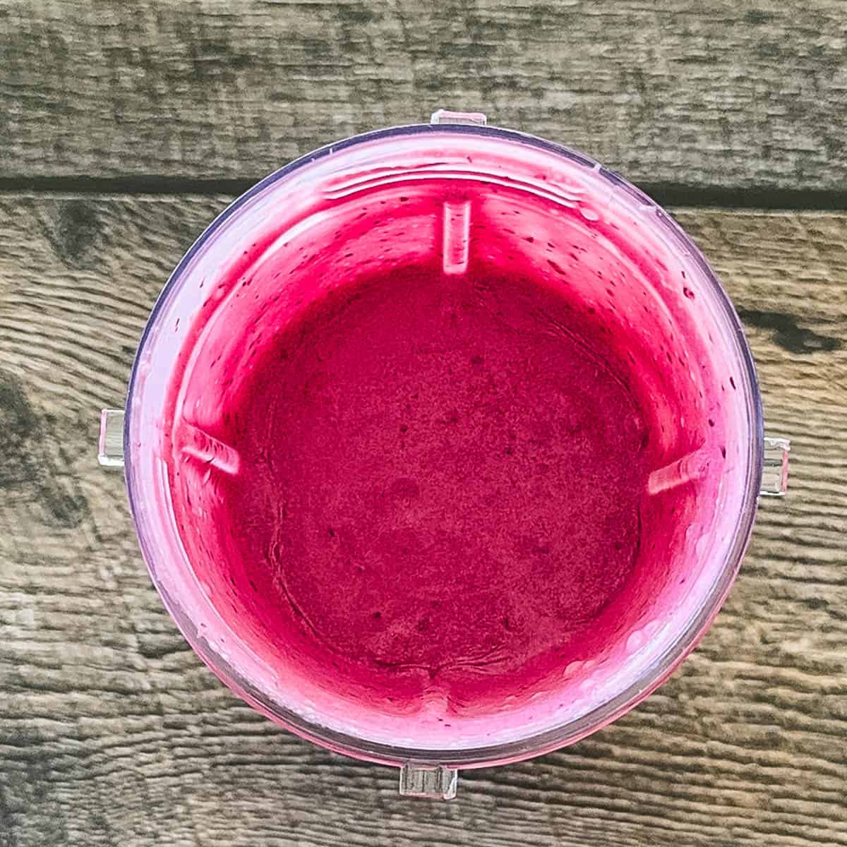 Cherry ice cream mixture in blender after blending.