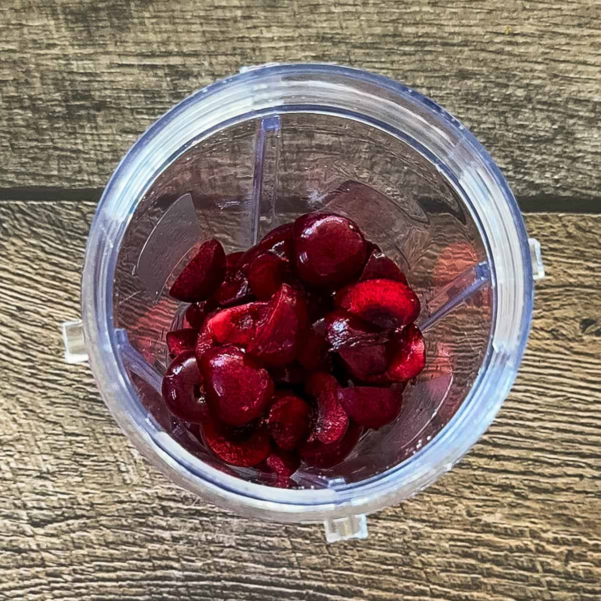 Fresh cherries with pits removed in blender.