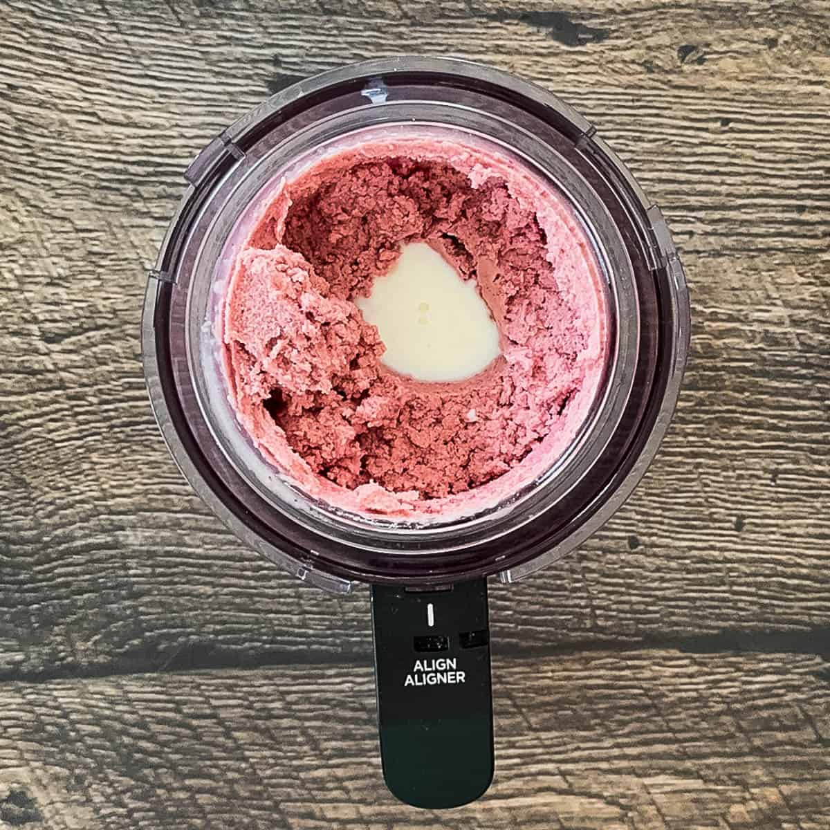 A tablespoon of milk added to a well in the center of the ice cream before re-spinning.