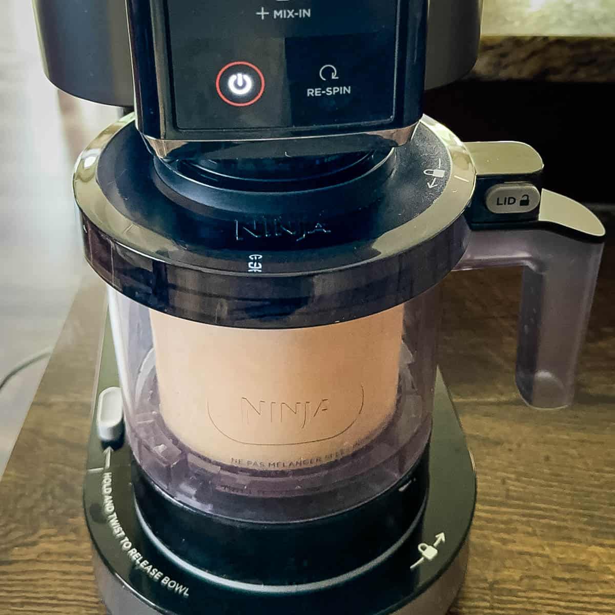 The maple ice cream being processed in the Ninja Creami ice cream machine.