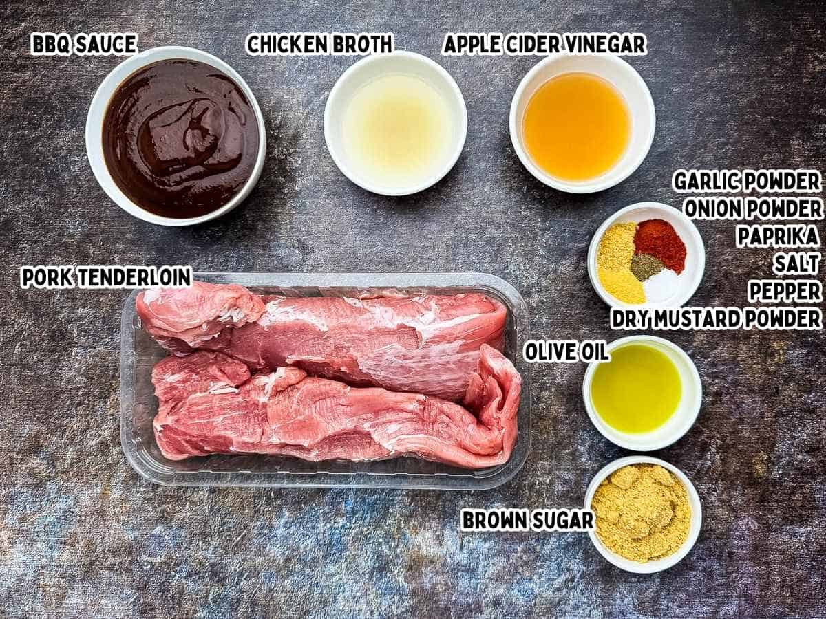 Labeled ingredients for BBQ pulled pork tenderloin including pork, BBQ sauce, vinegar, broth, brown sugar, and spices.