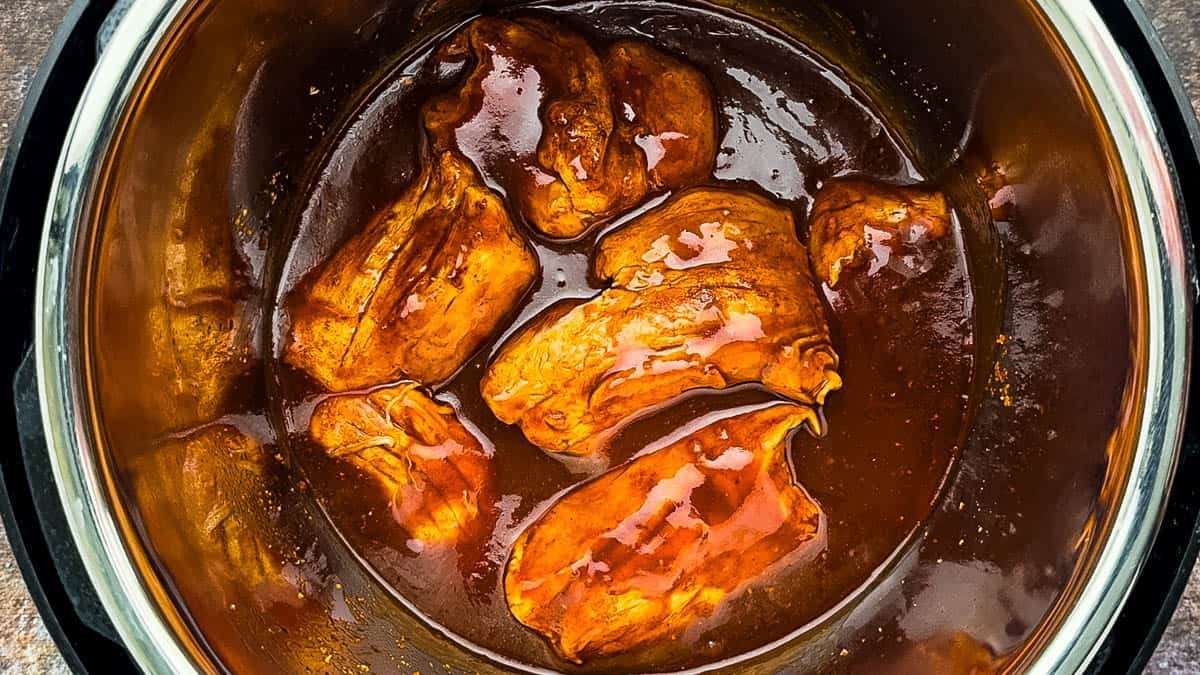 Pork tenderloin in BBQ sauce mixture in the Instant Pot.