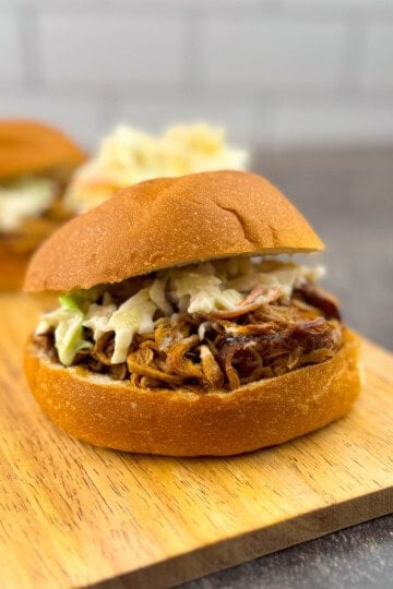 BBQ pulled pork tenderloin sandwich on a toasted bun topped with creamy coleslaw.