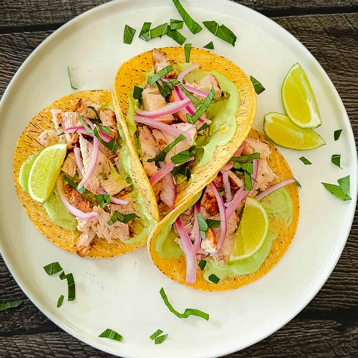 Sliced smoked chicken layered in tortillas with toppings.
