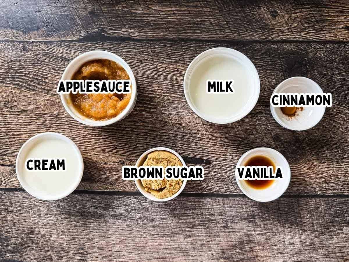 Labeled ingredients for Ninja Creami apple pie ice cream placed in small white bowls on a wooden table.